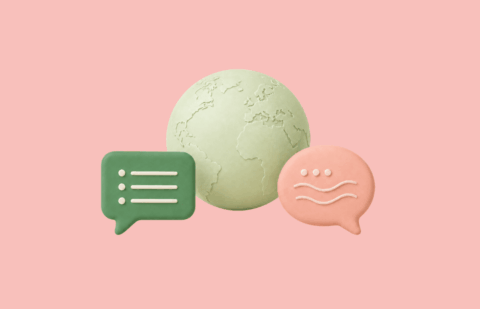 Globe with two different speech bubbles representing intercultural communication in the workplace.